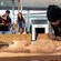 A family of Guests watching a Māori wood carver at work
